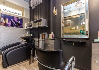Hair salon workstation featuring a clean and organized workspace with stylish salon chair, mirrors, and professional hairdressing tools.