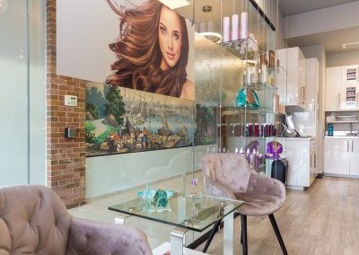 Comfortable and inviting hair studio waiting area with modern seating, stylish decor, and natural lighting, creating a welcoming ambiance for client