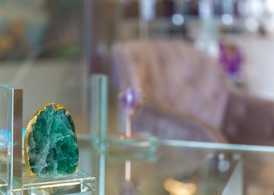 Display of exquisite crystals for sale at the hair studio, offering a variety of healing stones and gemstones in different colors and shapes, adding a touch of positive energy to the studio environment