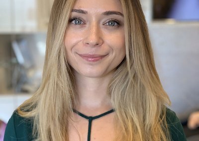 Balayage and cut transformation on blonde hair, featuring seamlessly blended caramel and honey tones, complemented by a chic layered haircut, creating a modern and radiant look